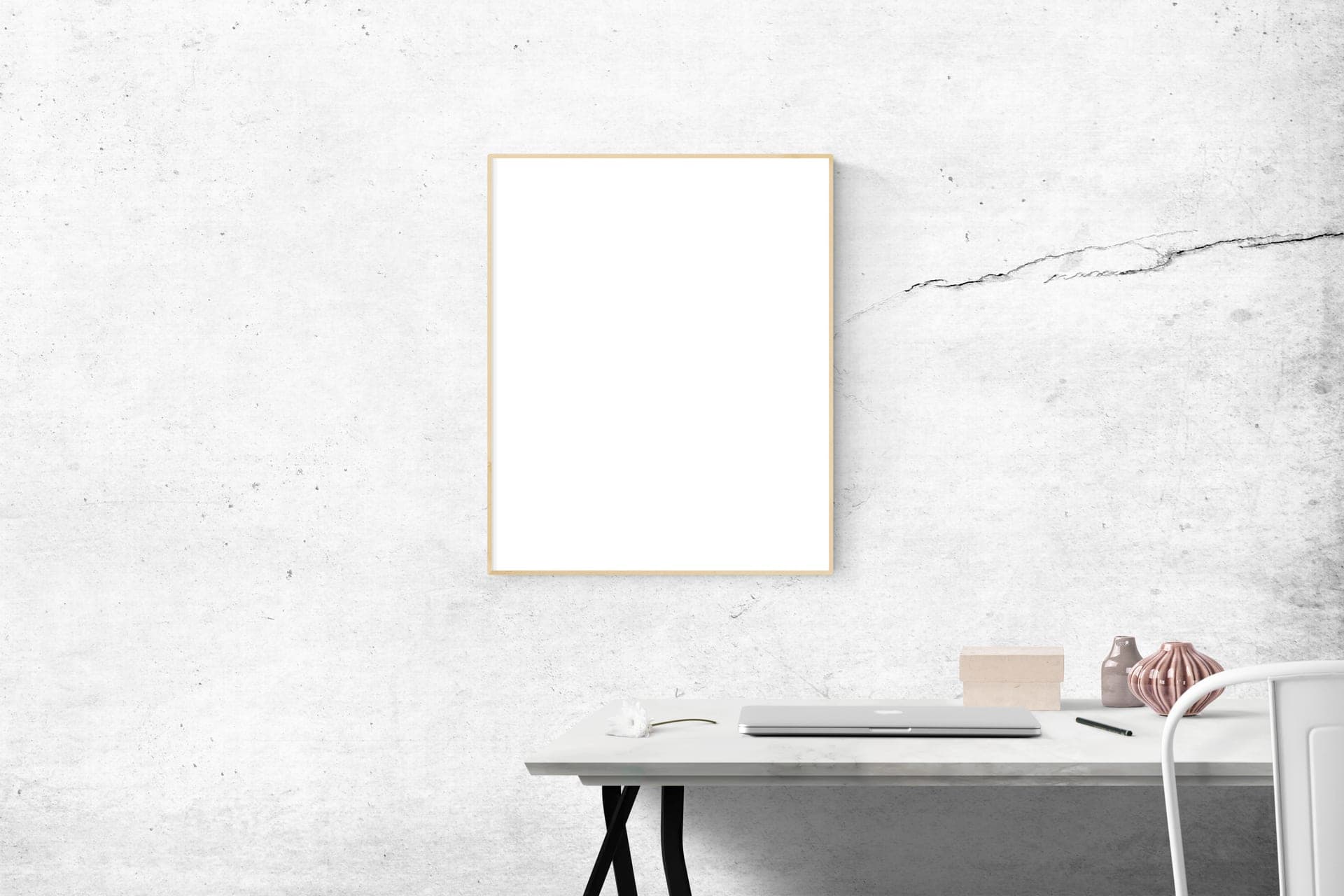 A large format poster frame hanging above a desk