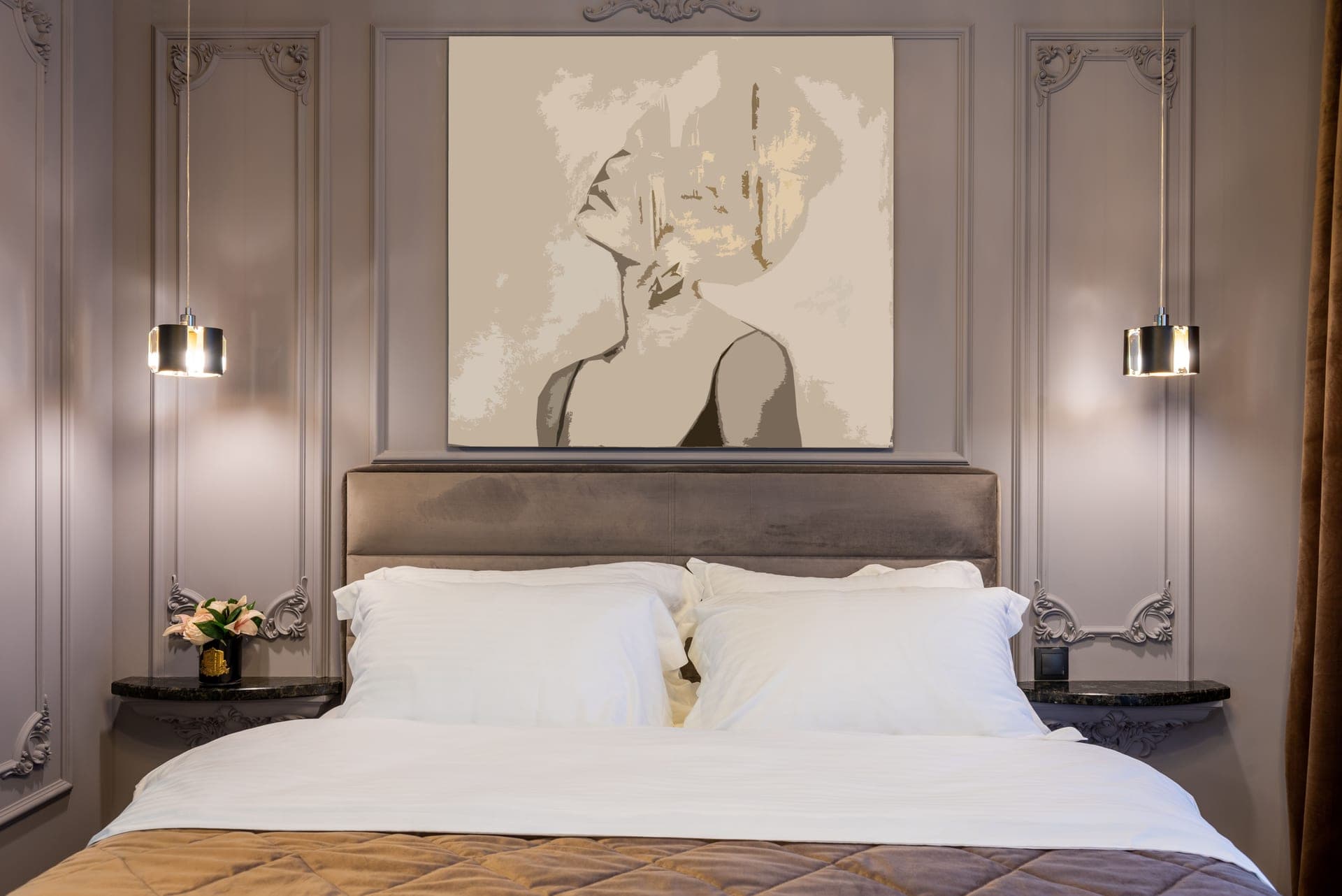 A wide framed print centered above an upholstered headboard