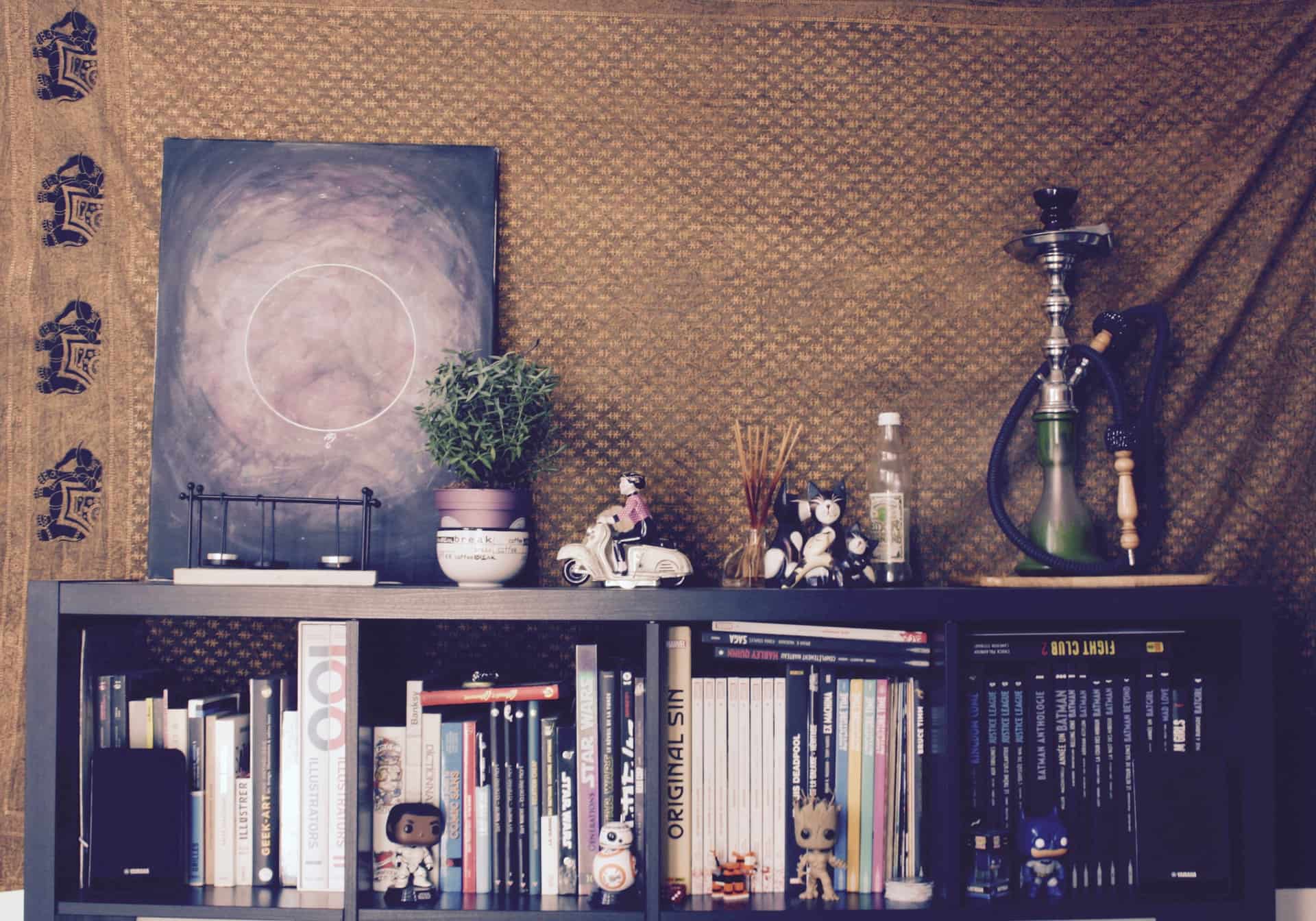 A large stretched canvas hanging above a low sideboard
