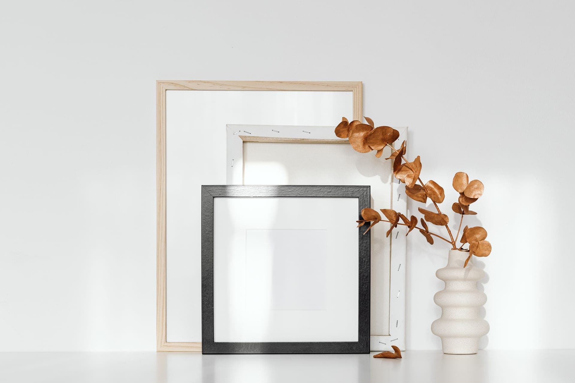 A simply framed print with a generous white mat on a plain wall