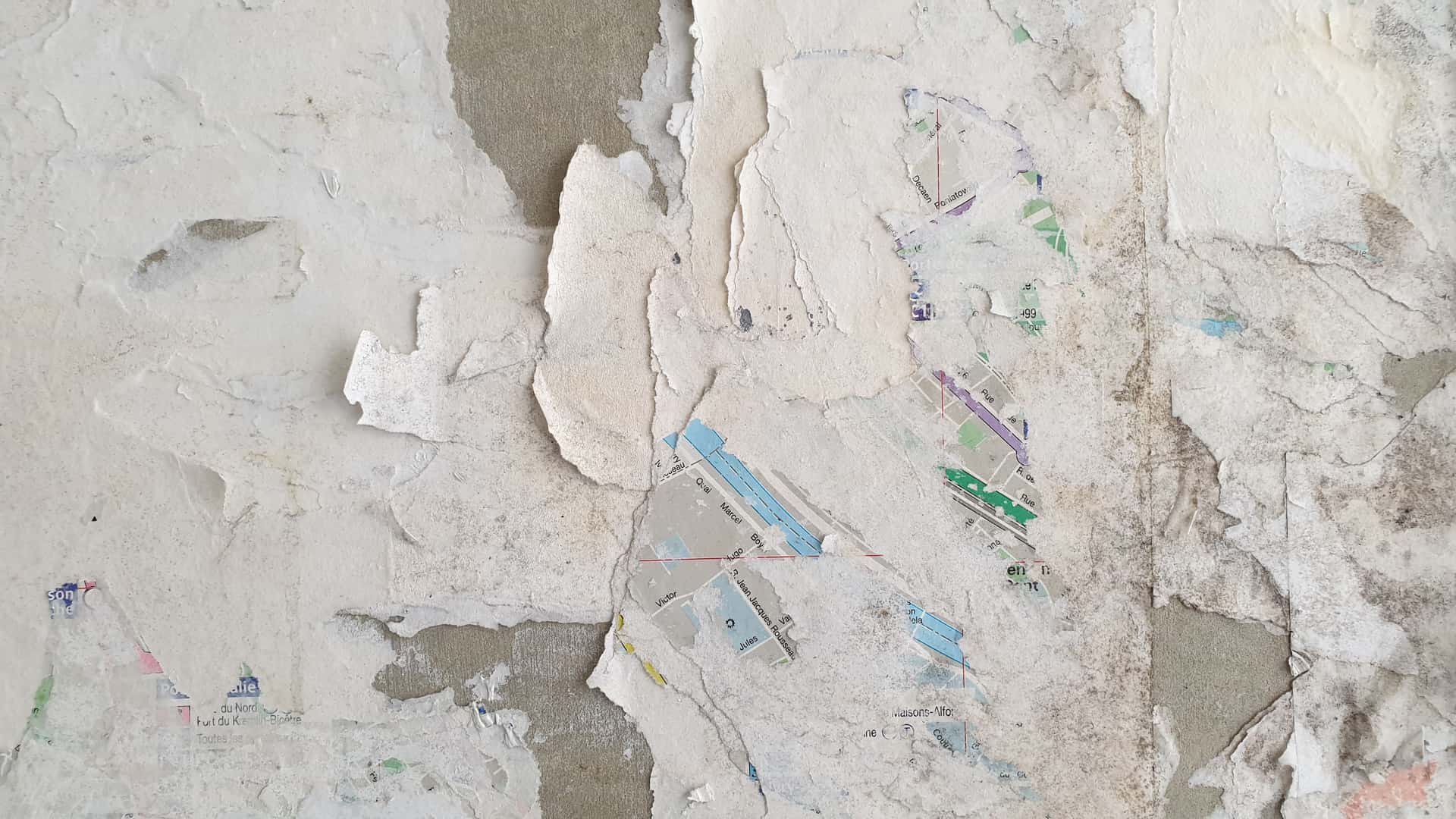 Peel-and-stick wall covering being applied to a plain wall