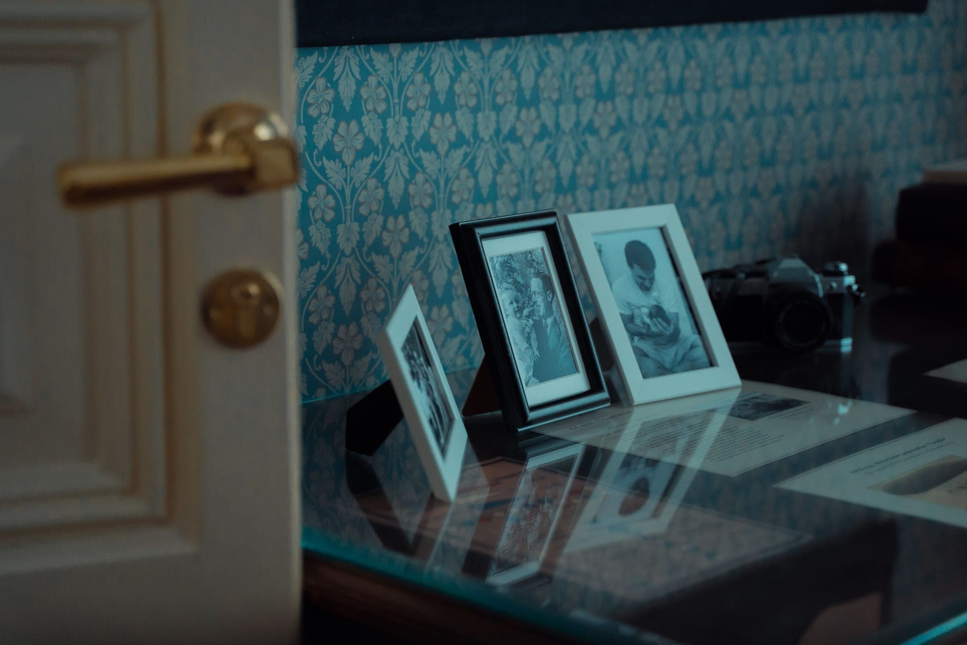 Light reflecting off the glazing of a framed print on a wall