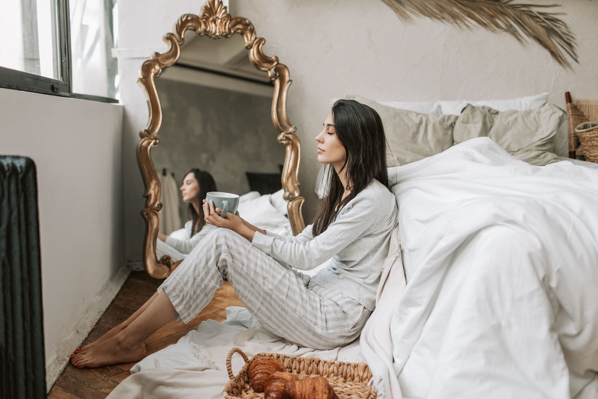 A large framed mirror leaning against a bedroom wall