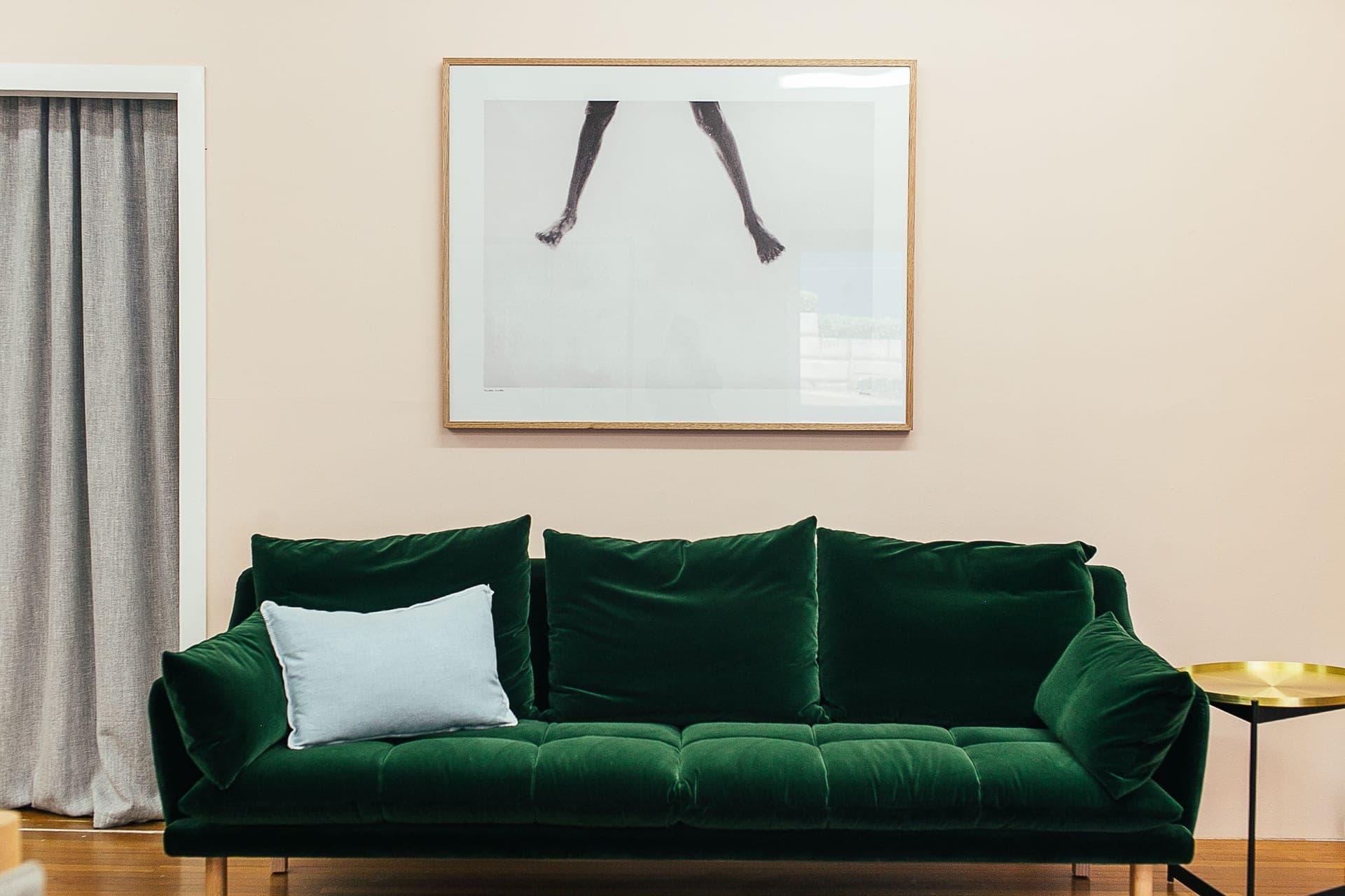 A large framed print above a sofa in a bright living room