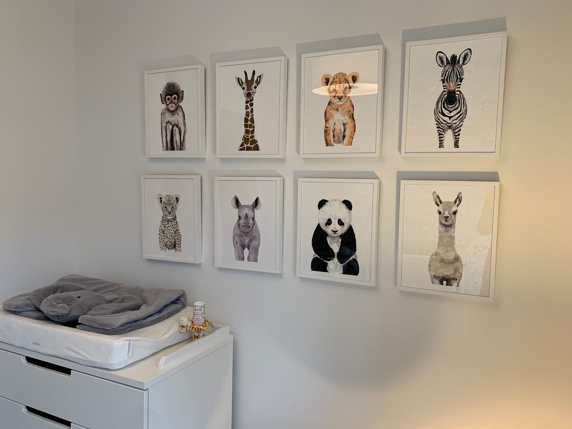 A framed print with a wide white mat border leaning on a shelf