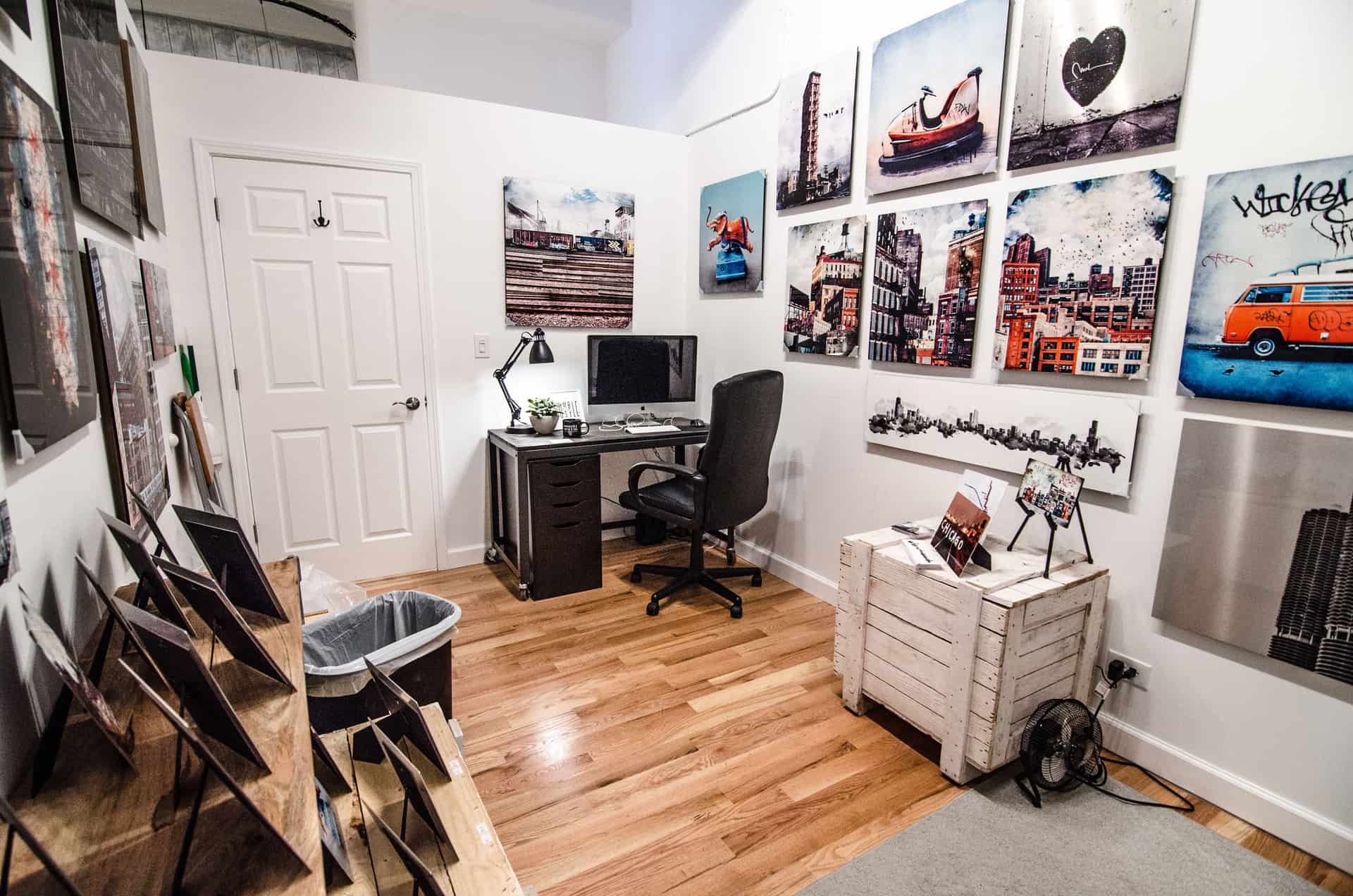 Framed prints on the wall behind a home office desk