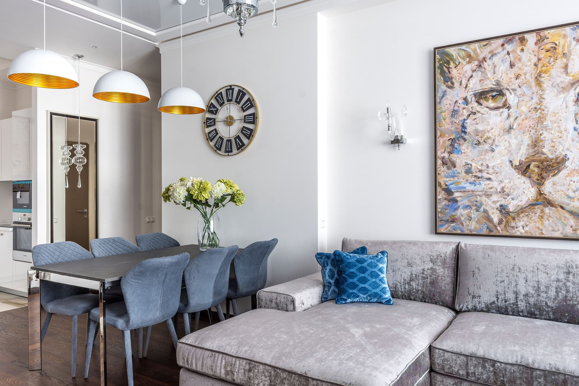 A framed print hanging above a sofa in a small, bright living room