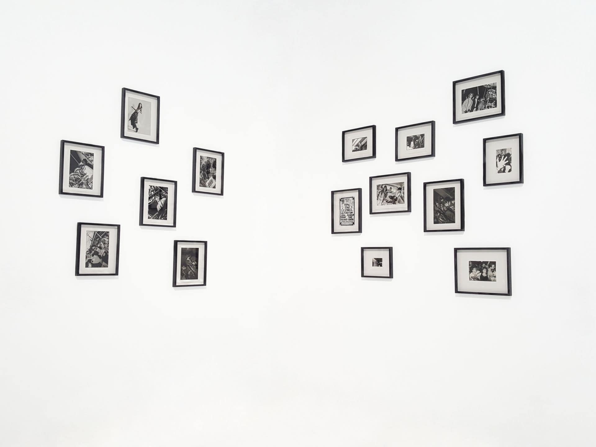 A row of black-framed photographs mounted on a pale wall