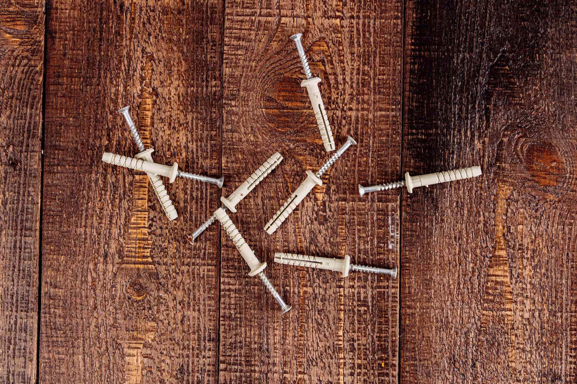 Assorted picture-hanging hardware arranged on a workbench