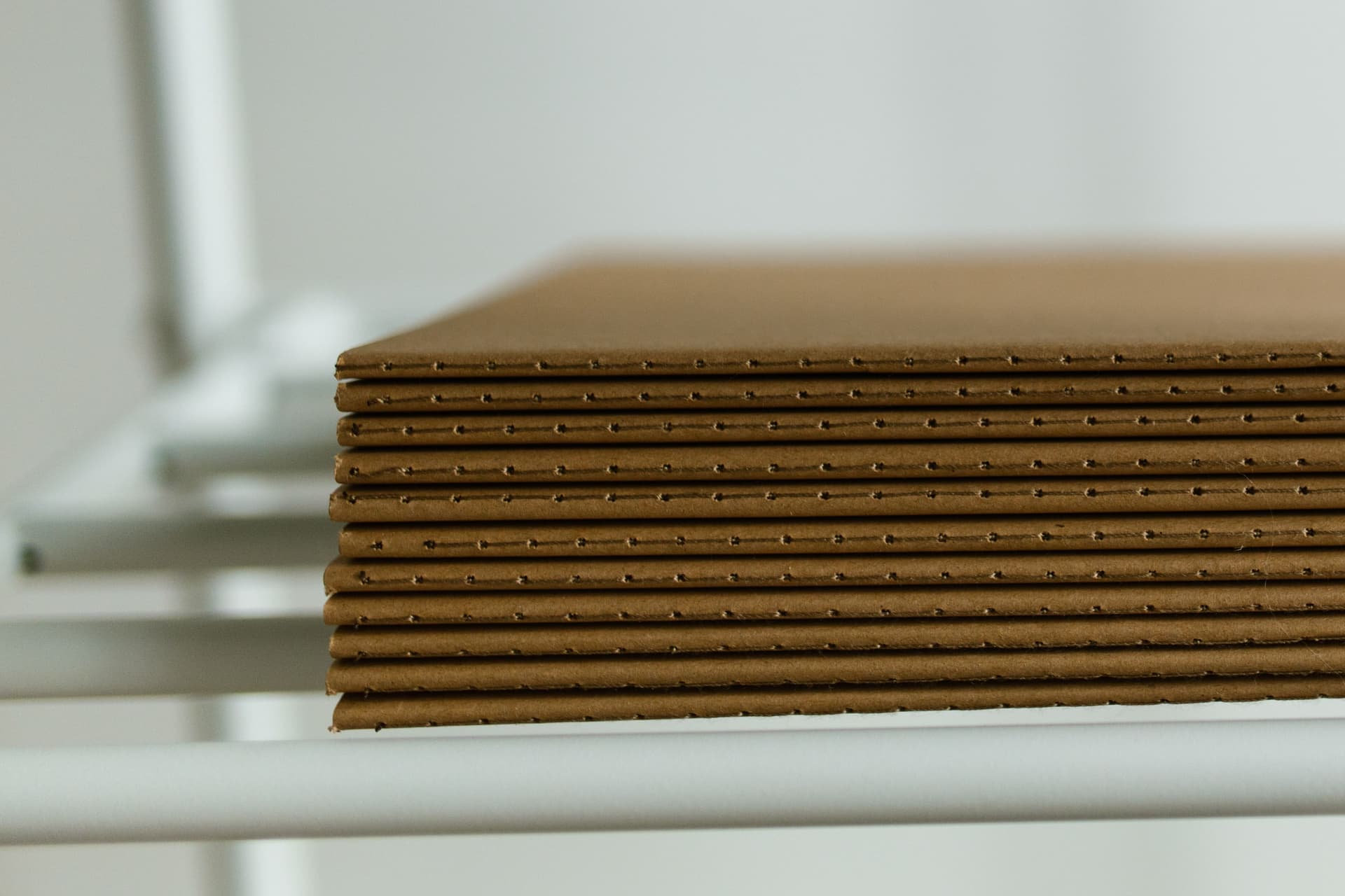 Cut mat board sheets with bevelled window openings on a work table